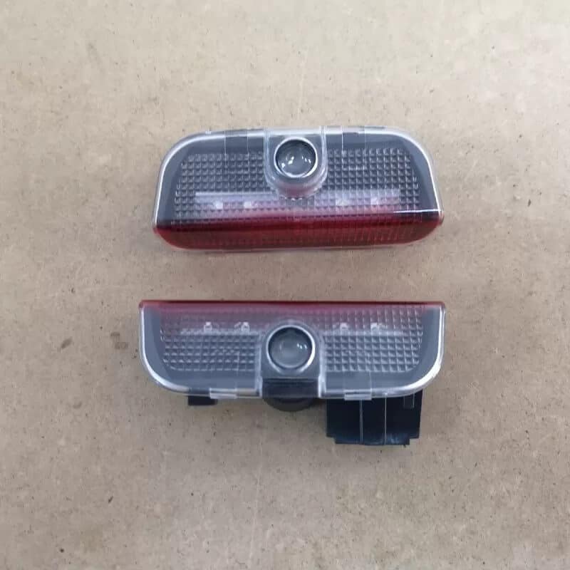 Auto si Moto - Piese auto si accesorii - Caroserie - Faruri, stopuri si proiectoare - Lampi logo portiere VW Passat B6, B7, CC, Golf 5, 6, 7, Touareg - Infinity.ro